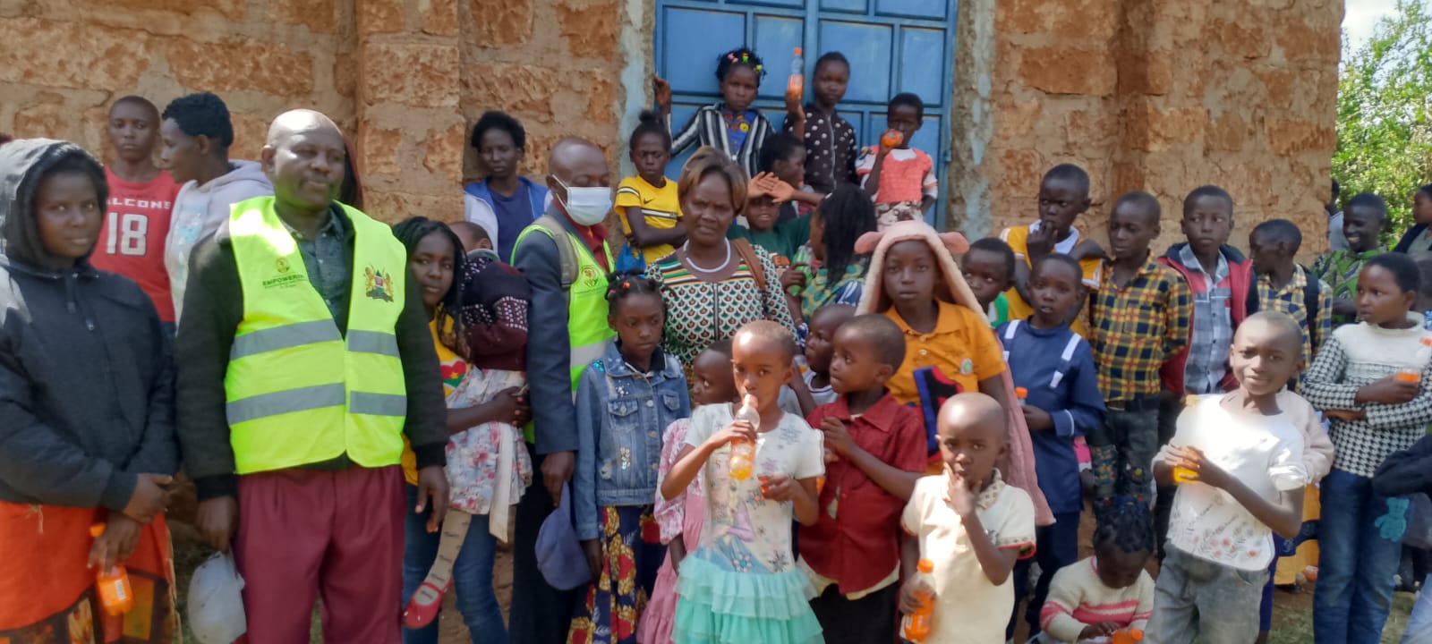 Outreach team with children at a community visit in Meru