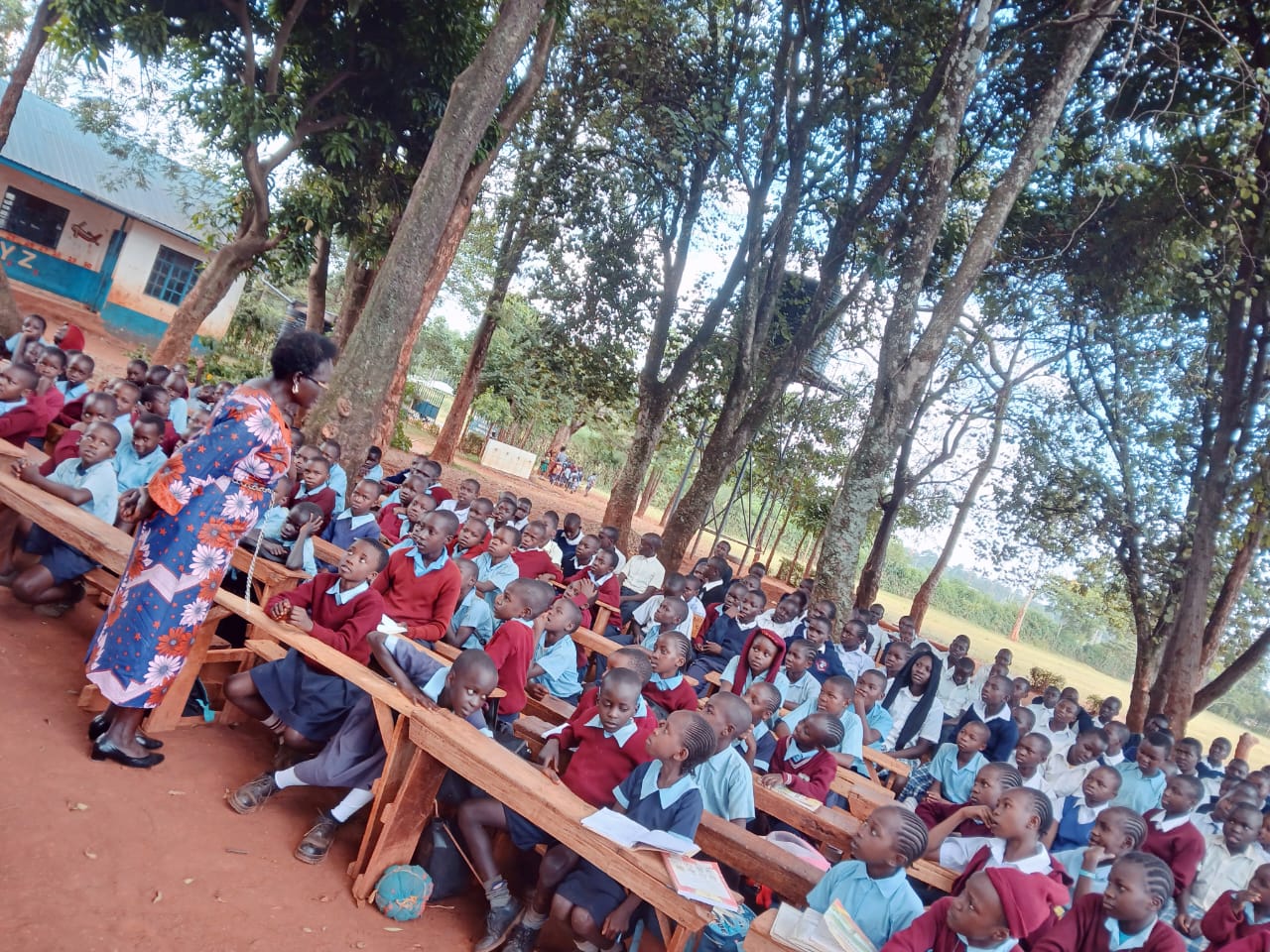 School outreach session with pupils under the trees
