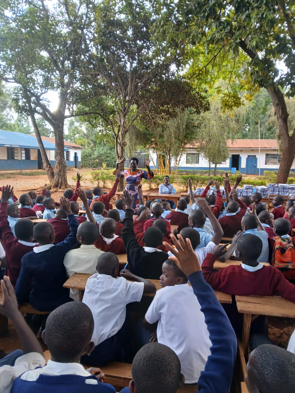 Pupils raising hands during a school engagement